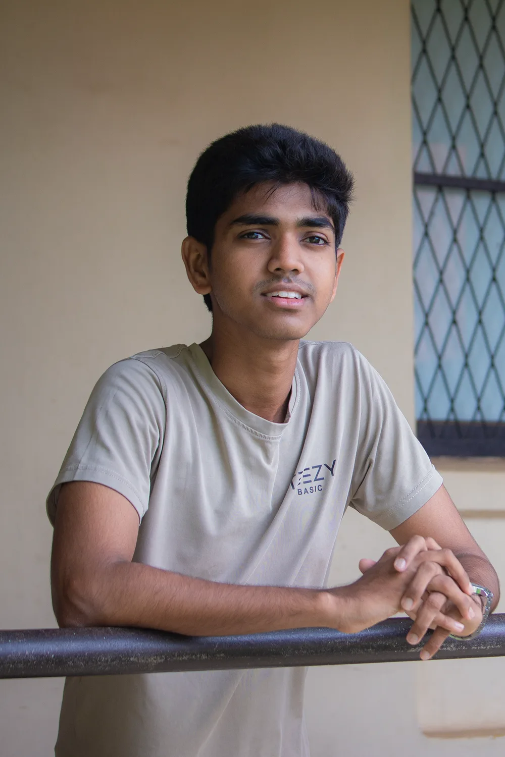 Gayuru Abhishek leaning on a balcony rail